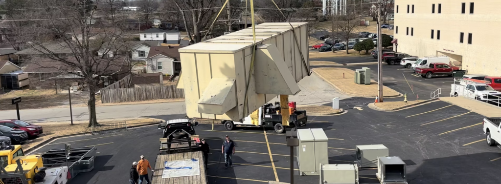 Old industrial AC unit being removed