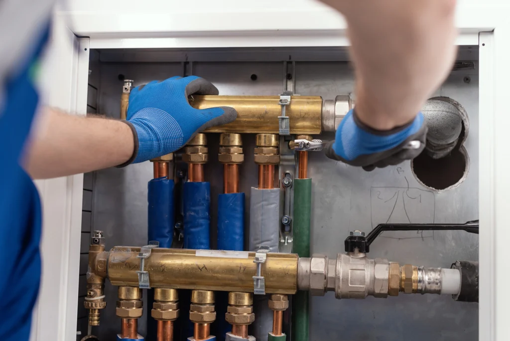 Hands repairing plumbing